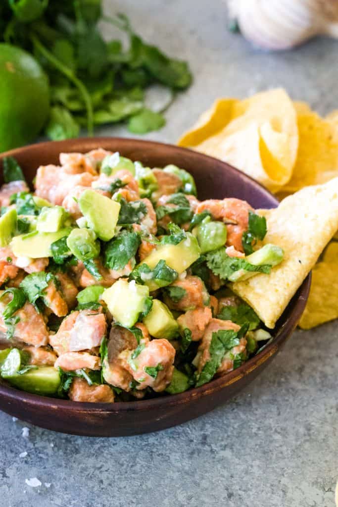 wooden bowl of salmon ceviche with tortilla chips