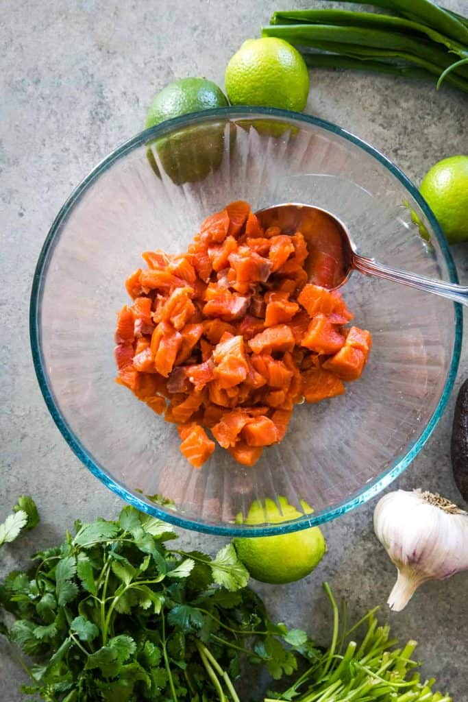 glass bowl of cubed raw salmon