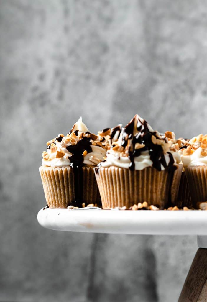 beer cupcakes on white cake stand and metal background