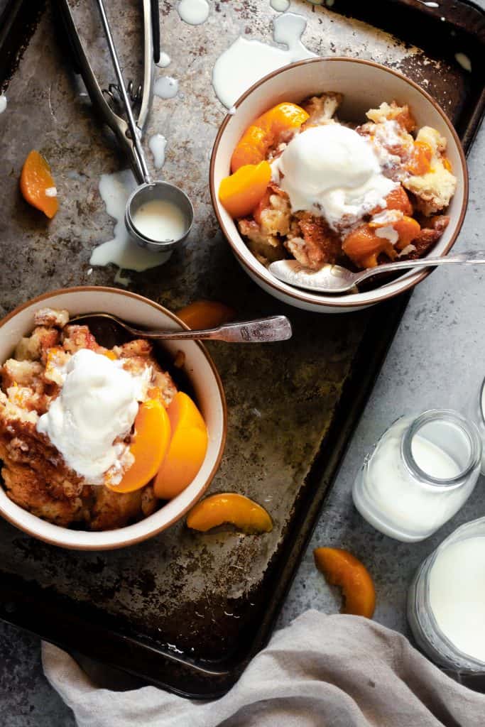 bowl filled with peach cobbler and ice cream