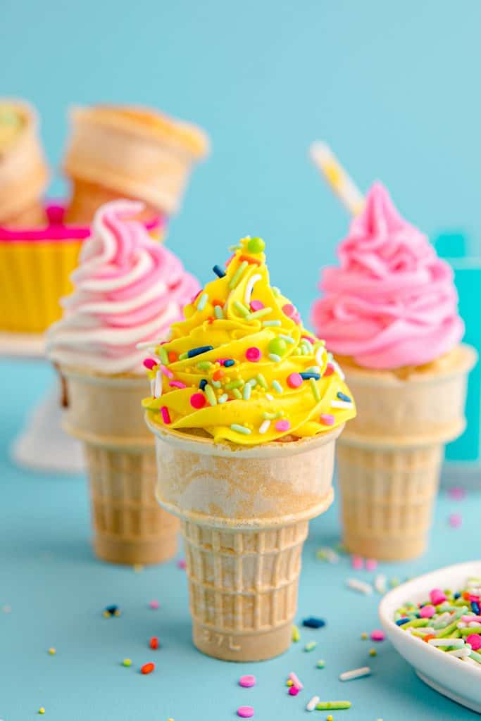 three ice cream cone cupcakes with sprinkles