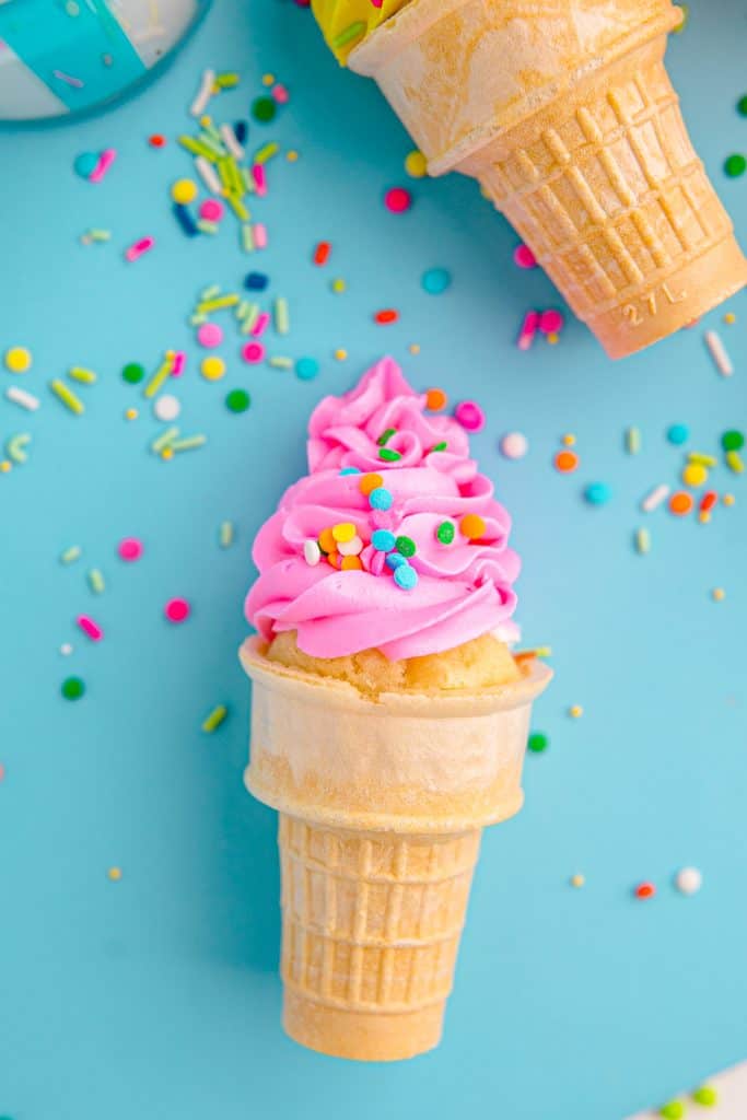 pink ice cream cone cupcake on blue background