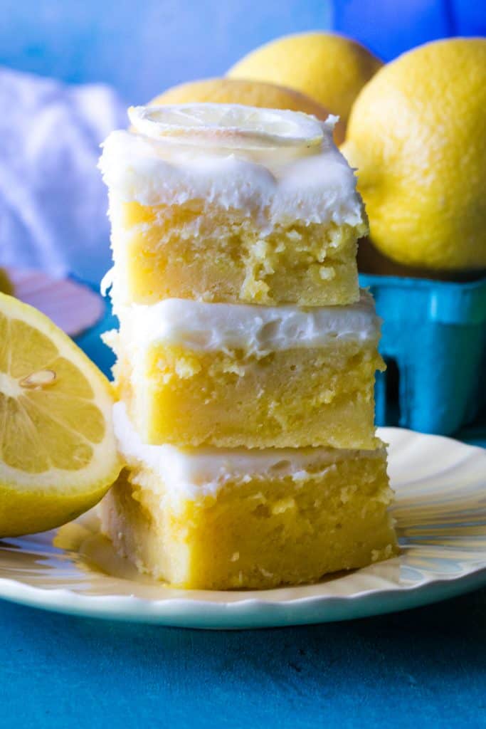 stack of three lemon brownies on yellow plate