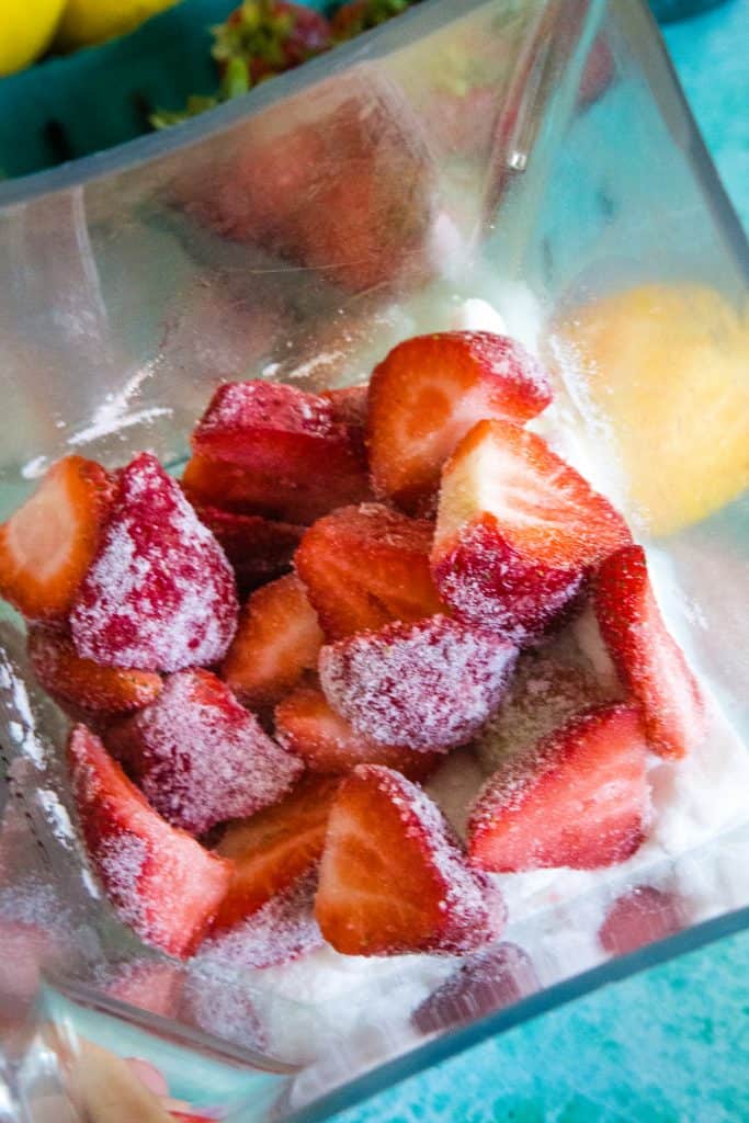strawberries in a blender with sugar