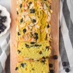 pumpkin blueberry bread on wood cutting board