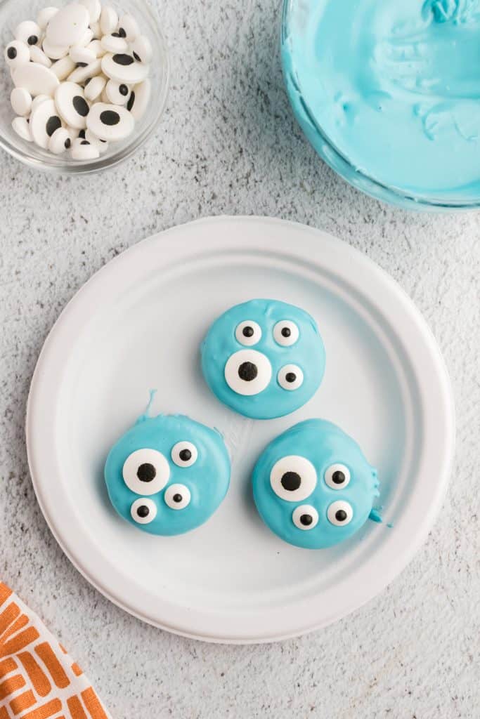 white plate with blue dipped Oreos and eyeballs