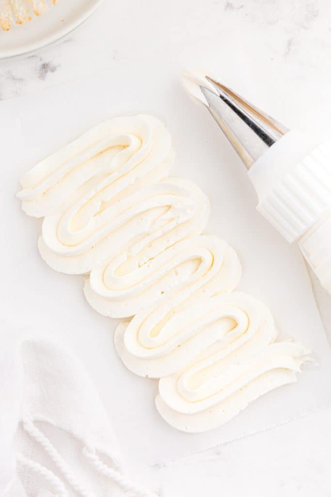 piping bag and tip with Swiss meringue buttercream frosting