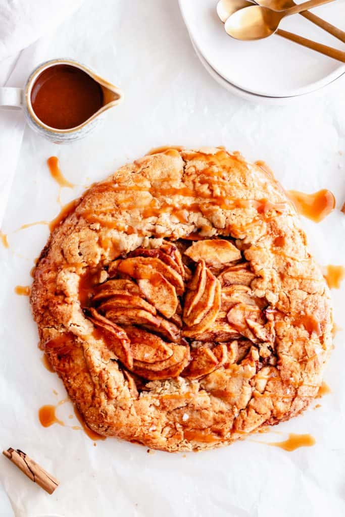 apple galette with salted caramel sauce on white background