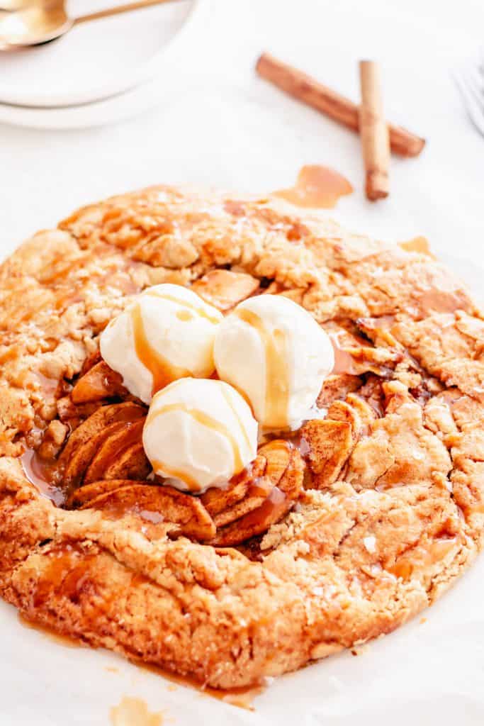 apple galette with 3 scoops of ice cream on white background