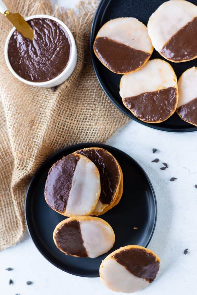 overhead shot of black and white cookies on black plate