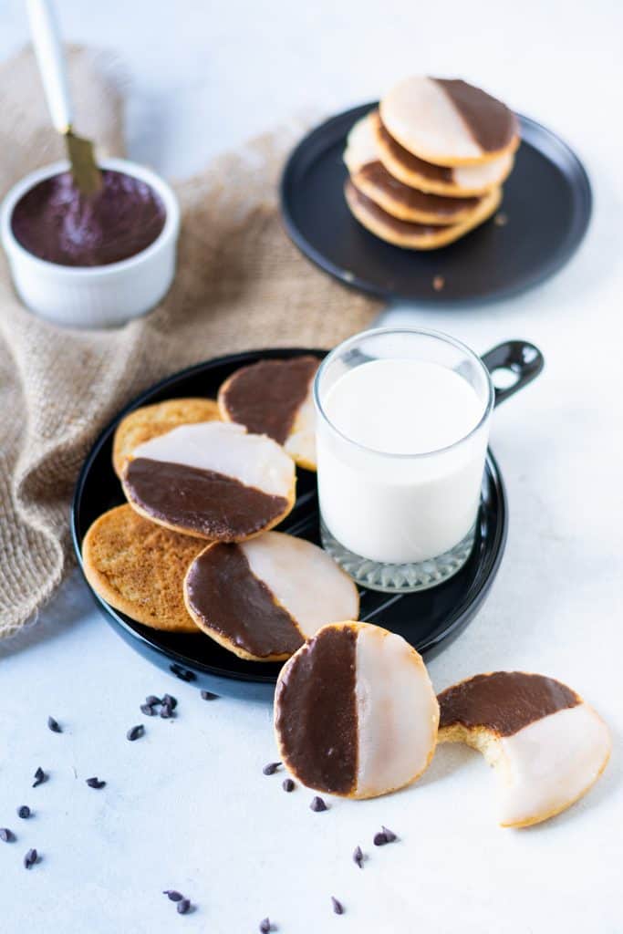 two black plates with black and white cookies on them