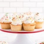 white cake plate with white cupcakes