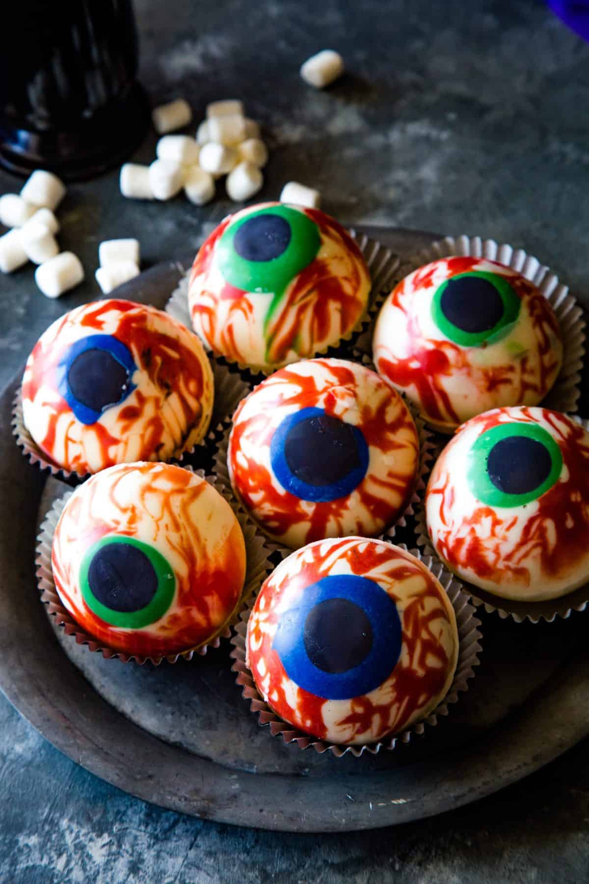 Overhead shot of the eyeballs on a silver plate on metal background.