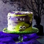 monster eye cake on green cake stand and grey background
