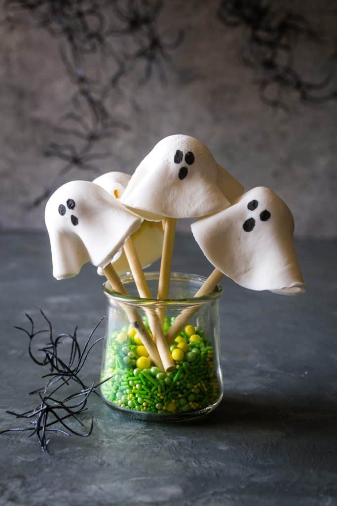 donut hole ghosts in a cup with green sprinkles