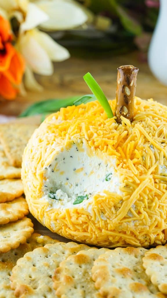 pumpkin shaped cheeseball with chunk scooped out