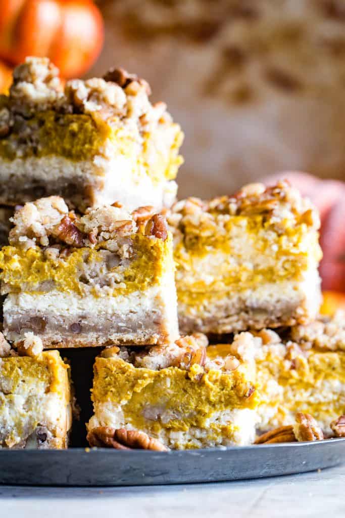 up close shot of plate of stacked cream cheese pumpkin bars