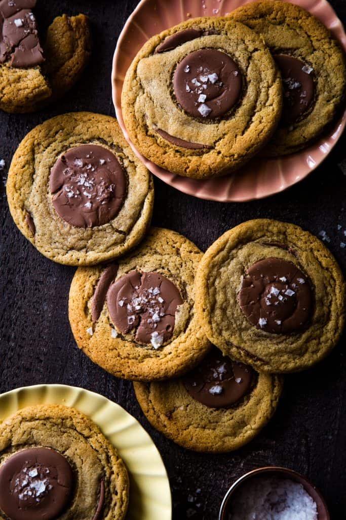 plates of whole wheat chocolate cookies scattered around