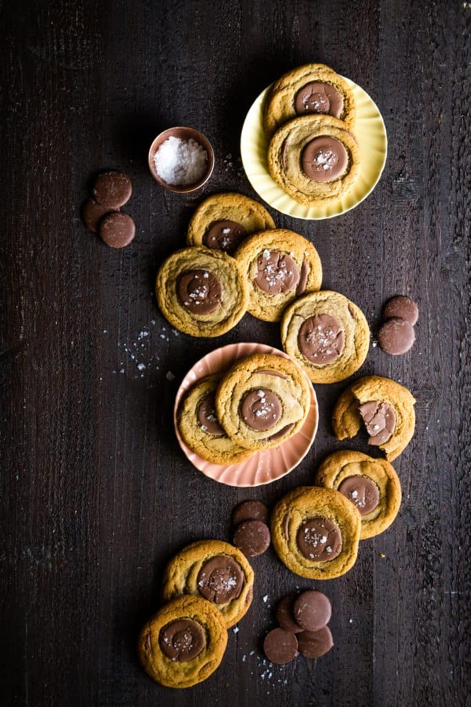 whole wheat chocolate cookies scattered on brown background