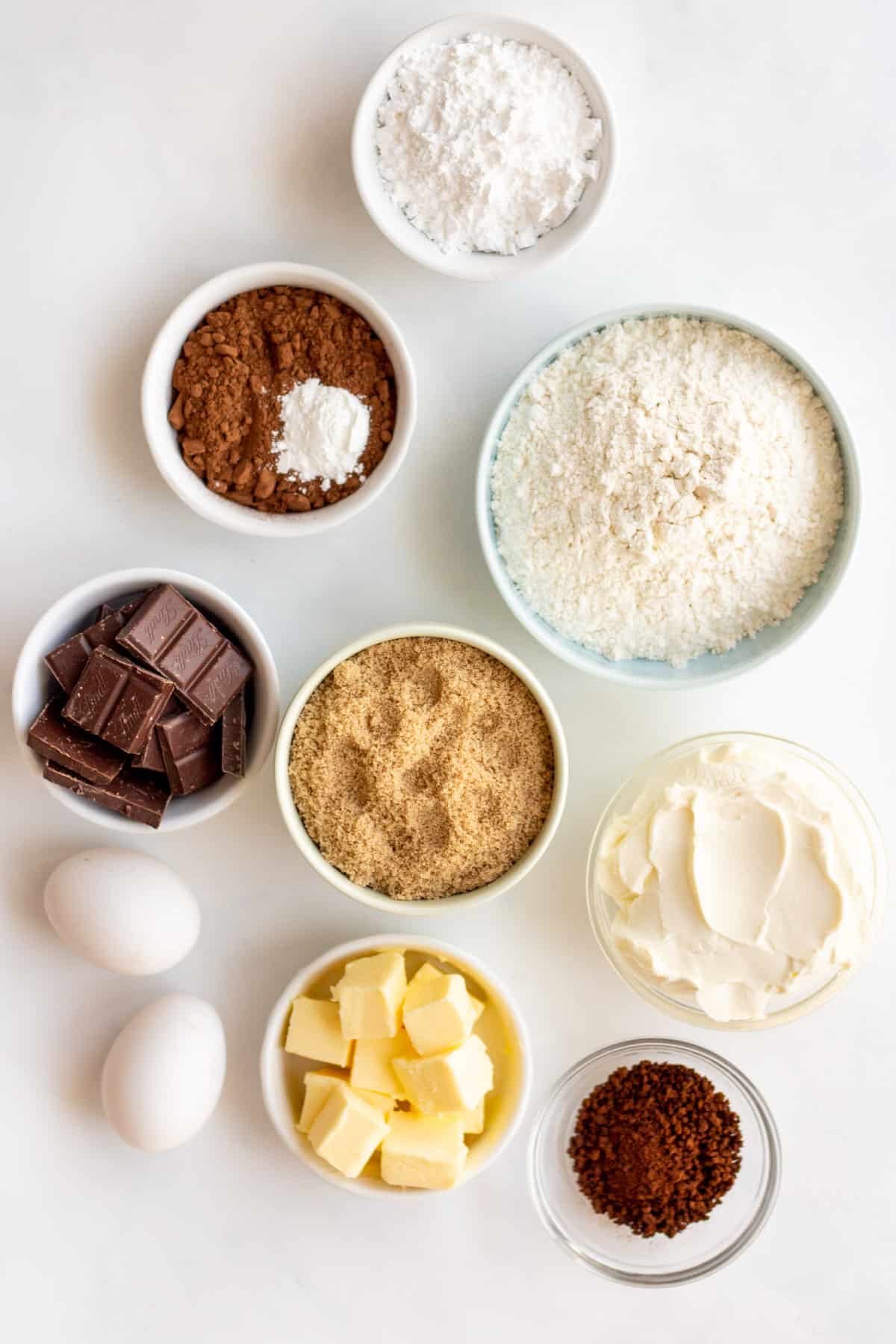 ingredients in small white bowls to make the brownie cookies