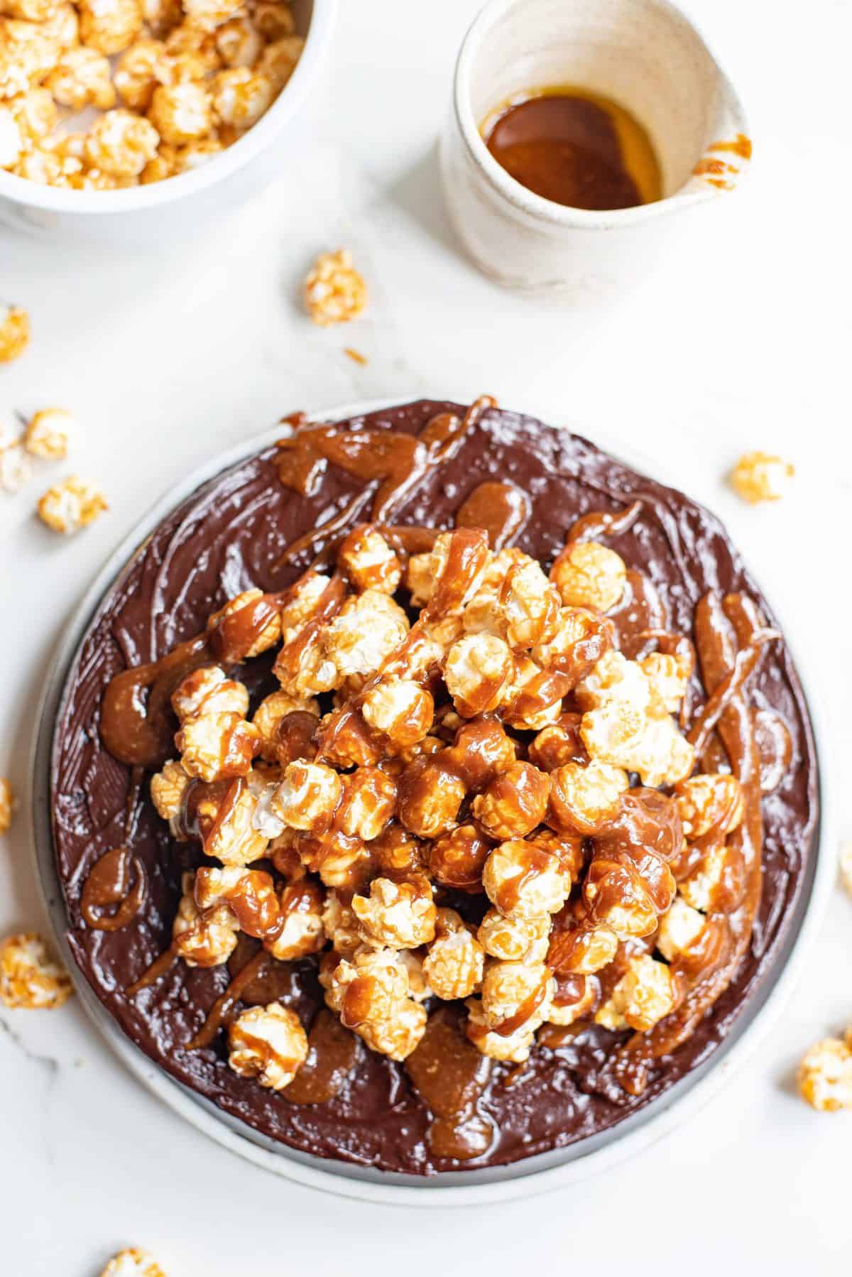 chocolate cake with caramel corn on top on white plate