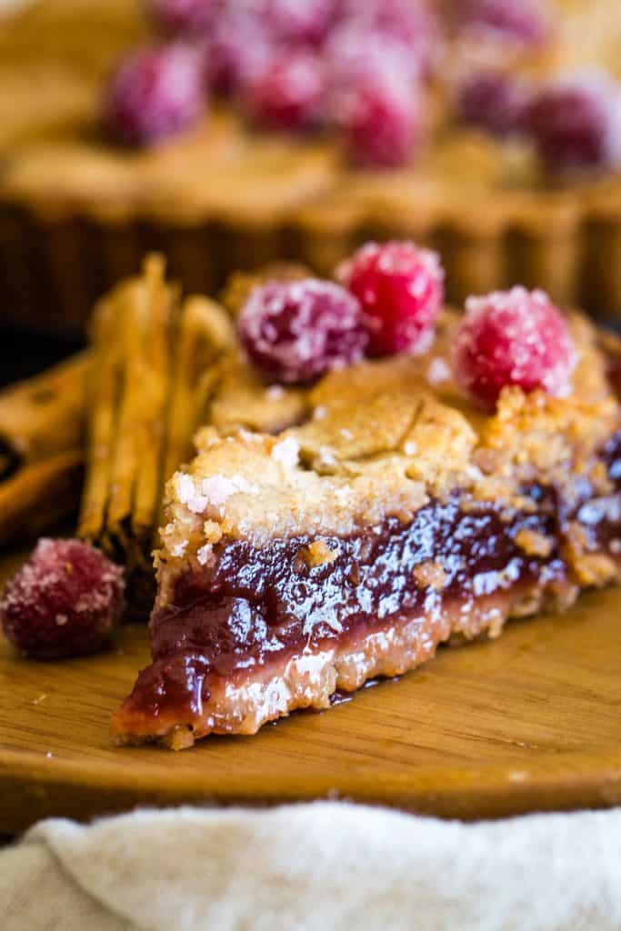 slice of the cranberry tart on wooden plate