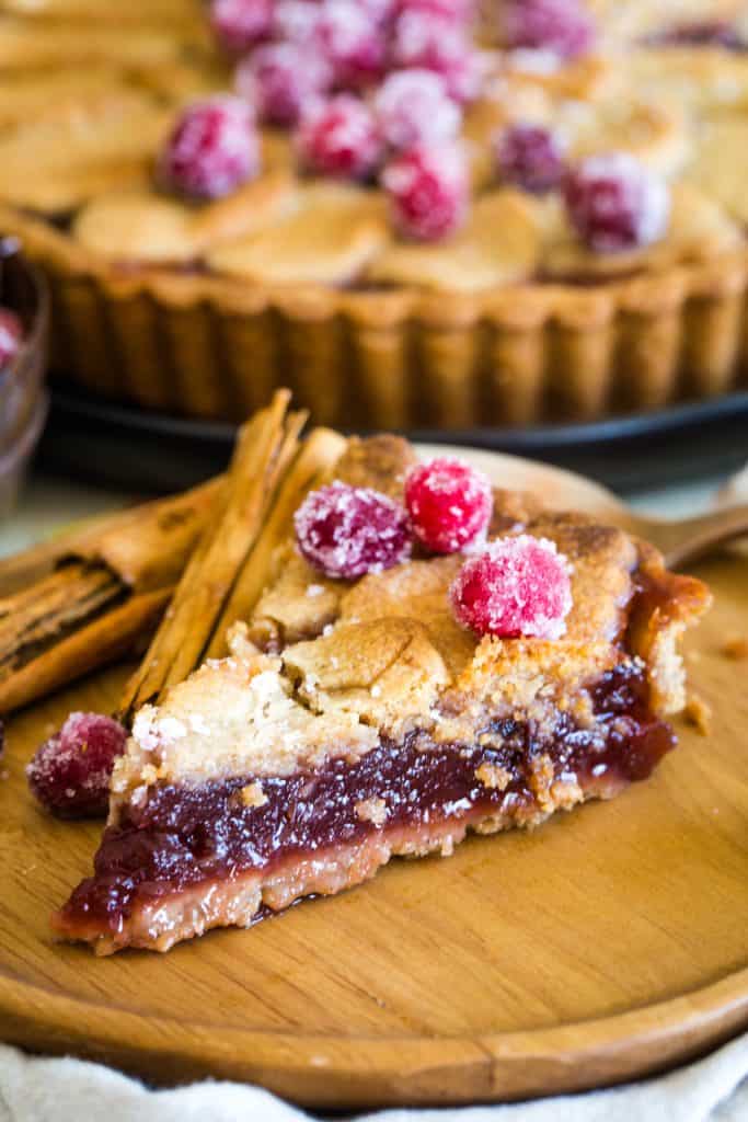 slice of cranberry tart on wooden plate