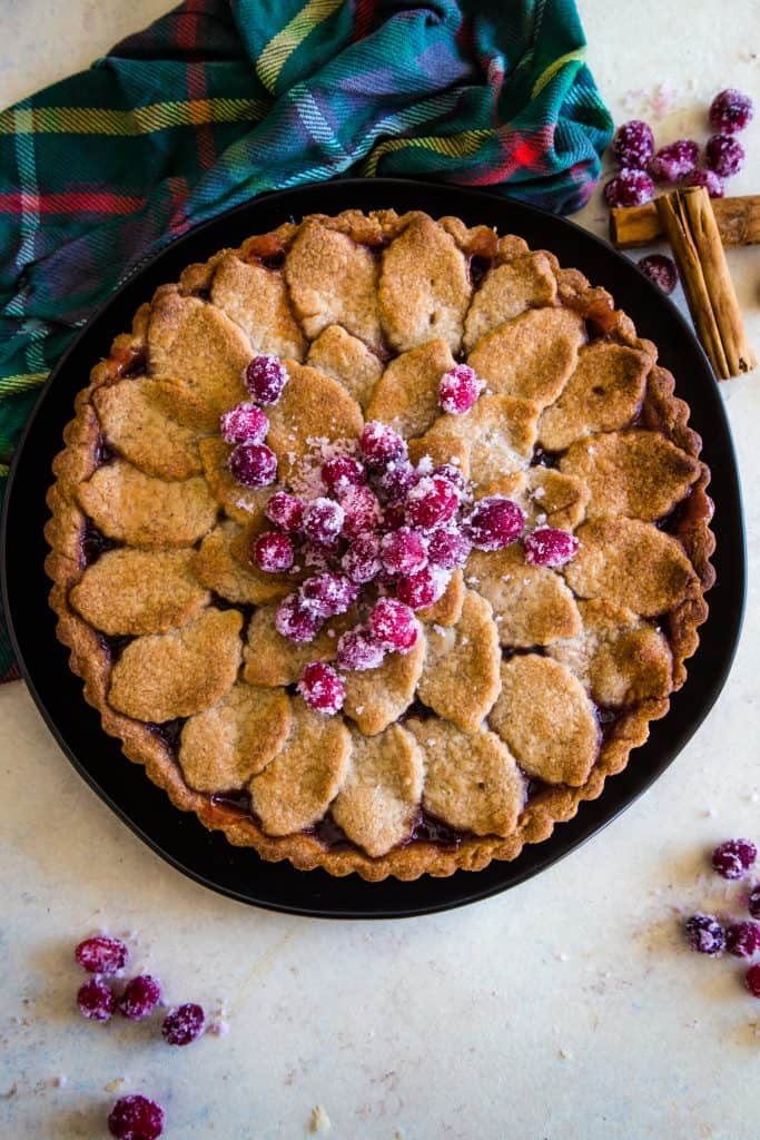 whole cranberry tart with sugared cranberries on top