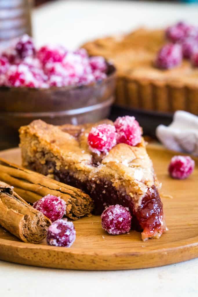 sliced cranberry tart on wooden plate