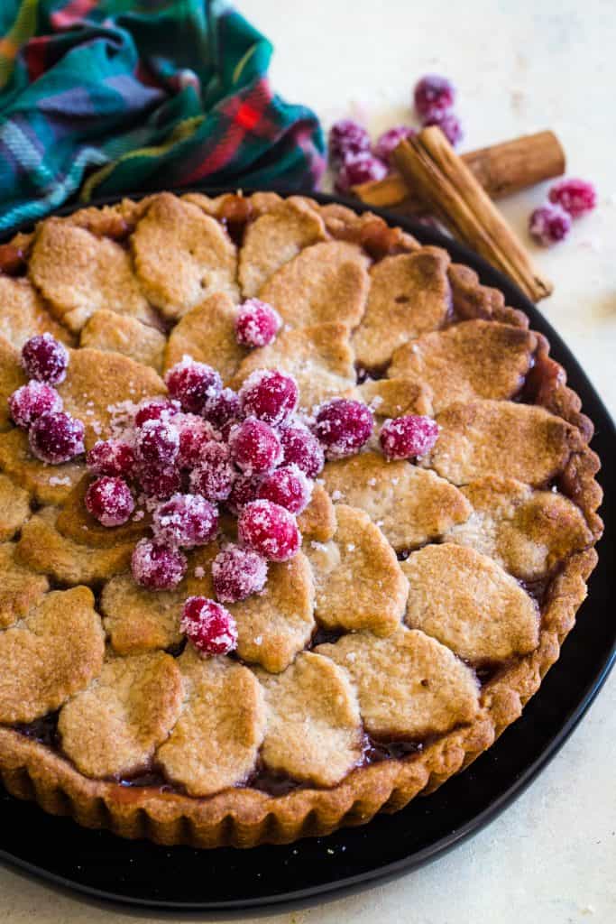 whole cranberry tart on black plate