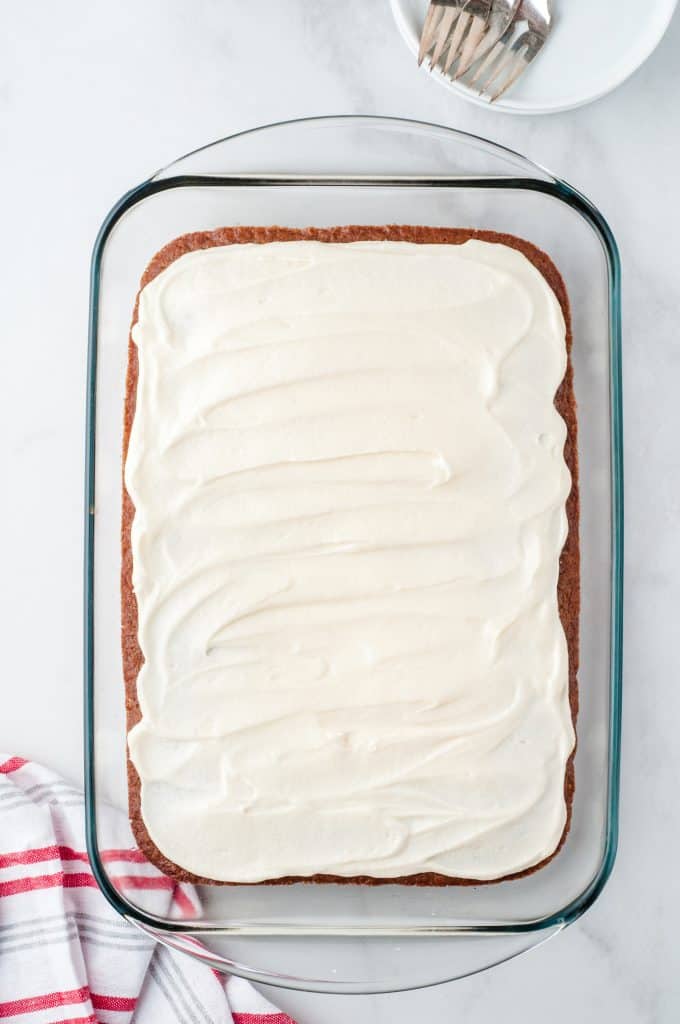 frosted gingerbread cookie bars in glass pan