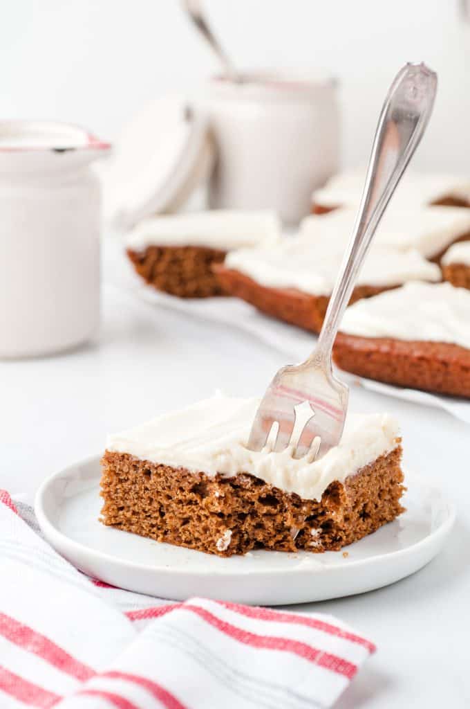 gingerbread cookie bar on white plate with fork in it