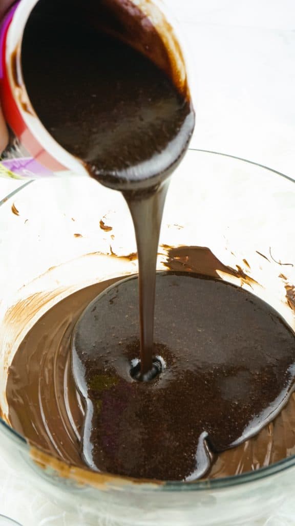 pouring the melted frosting into the chocolate