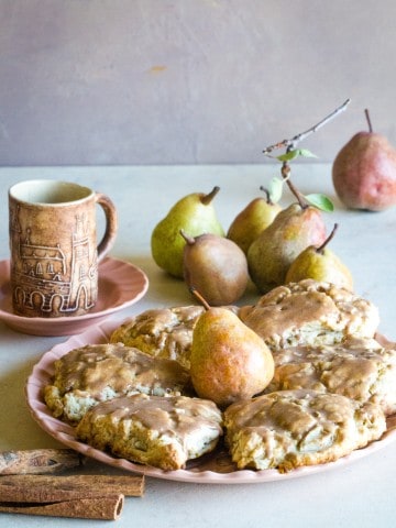 cinnamon glazed pear scones on peach plate