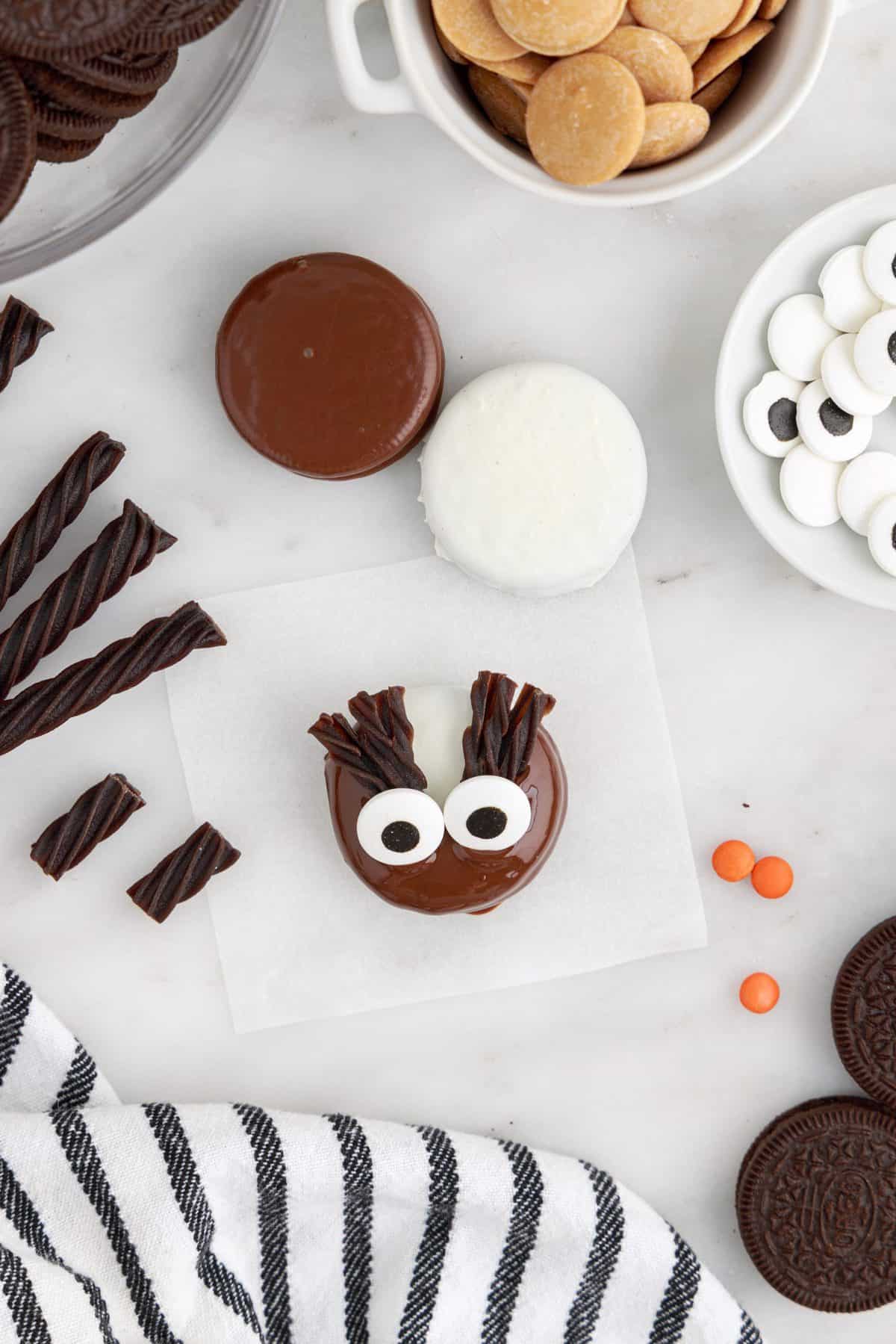 placing the eyeballs and eyelashes to make the cookies look like owls