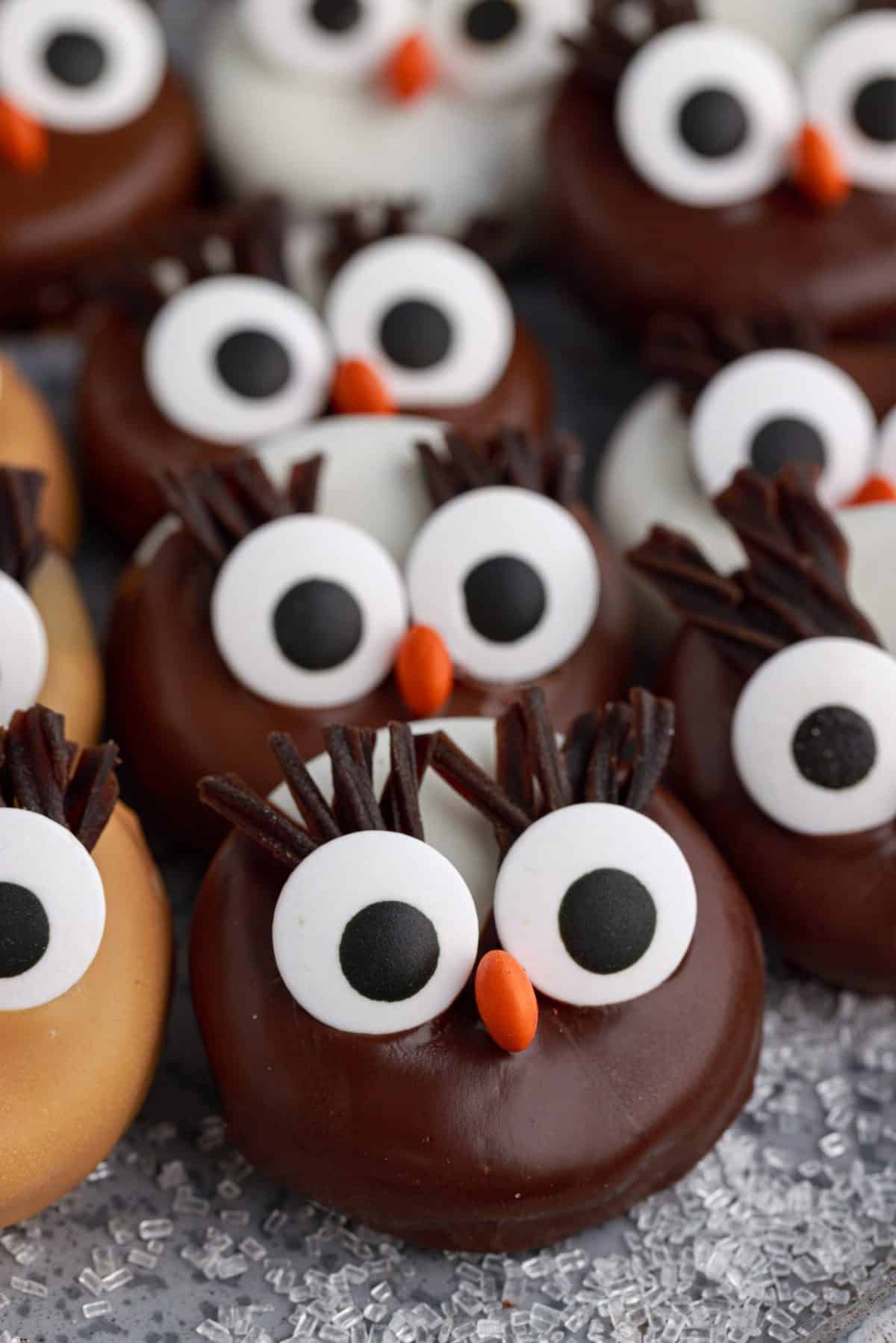 a metal tray of chocolate and peanut butter decorated owl cookies