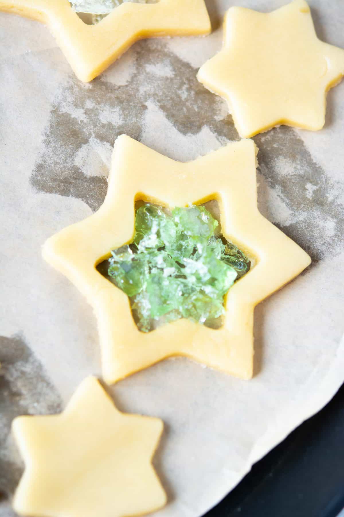 adding the crushed candies to the star cookies