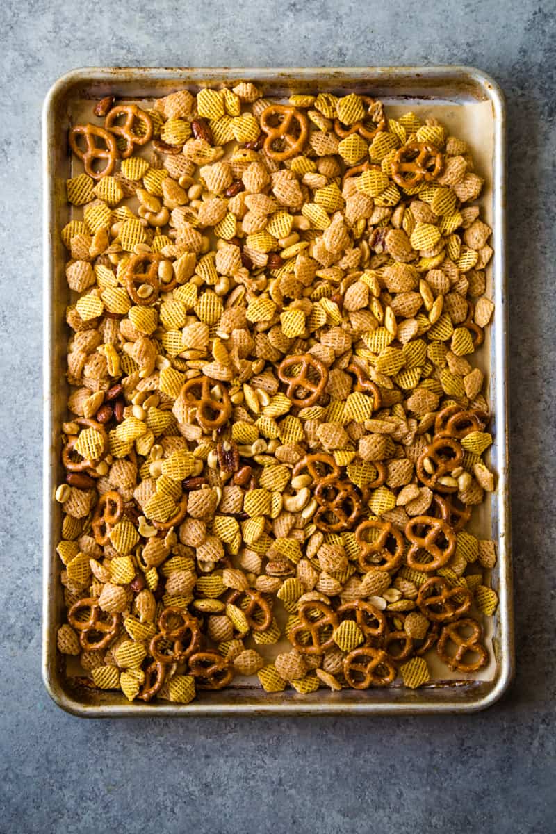 big metal tray of rosemary Chex mix ready to go in the oven