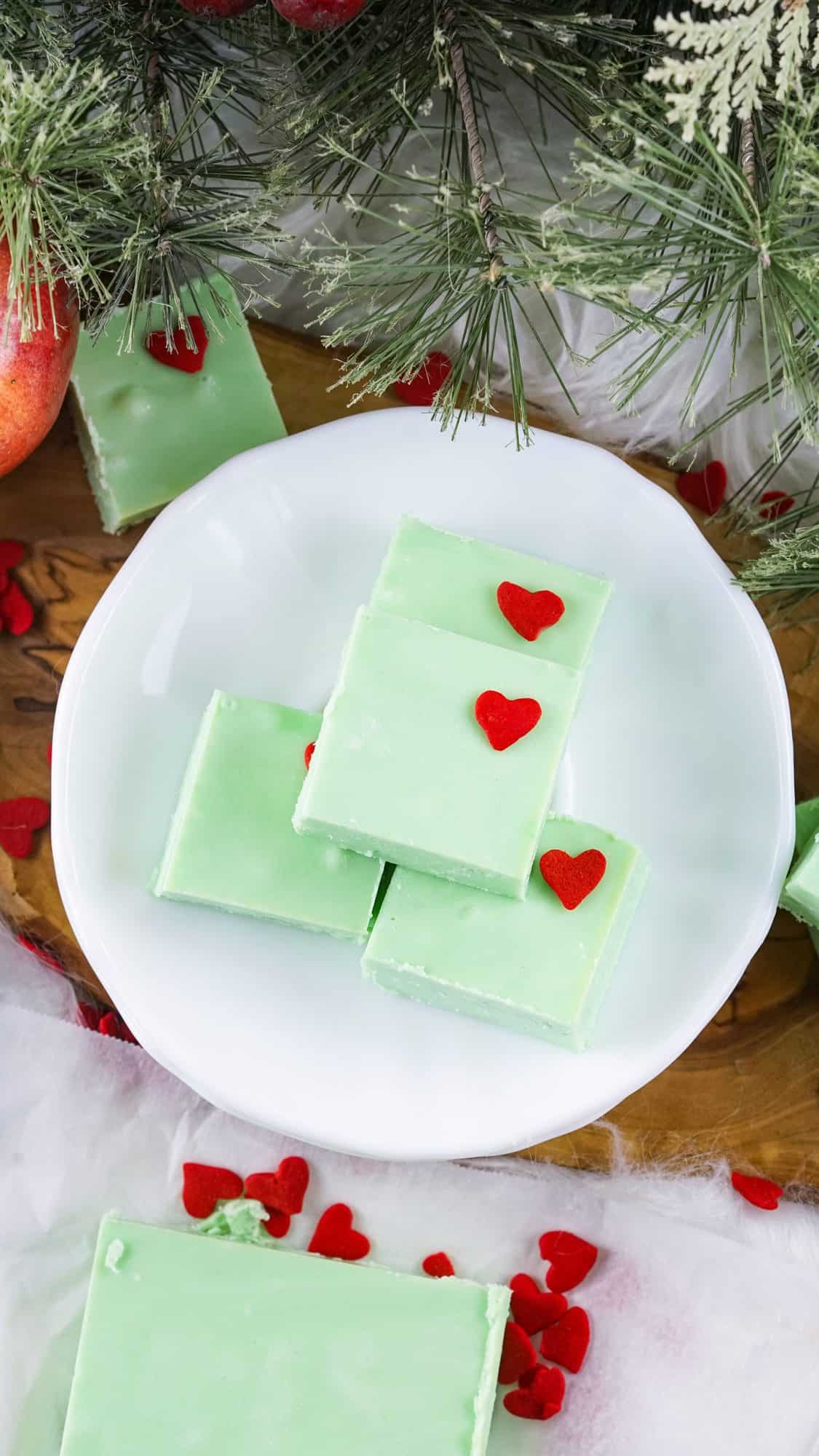 green grinch fudge on white plate with pine in the background