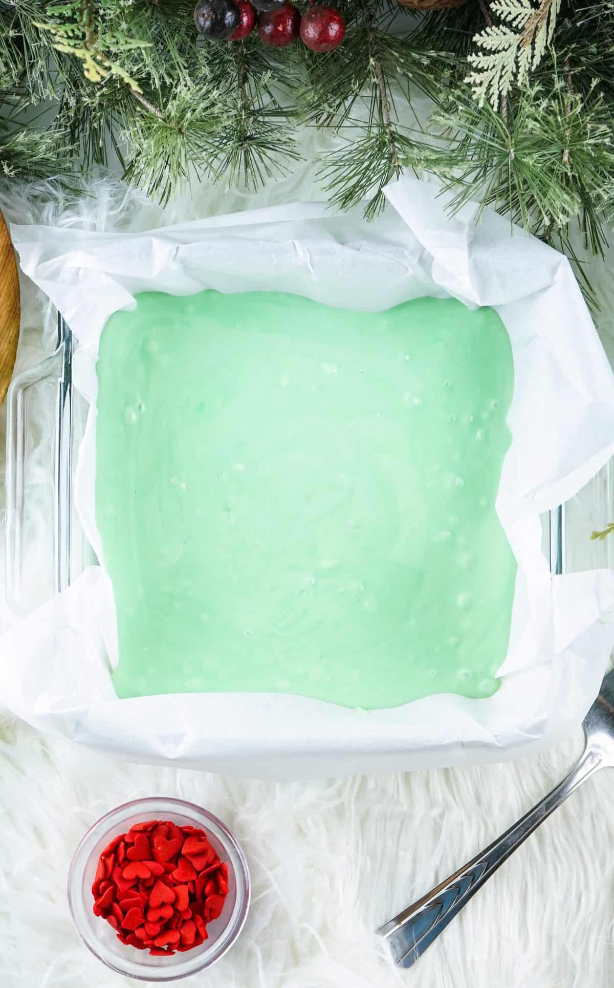 green grinch fudge in pan with parchment paper 