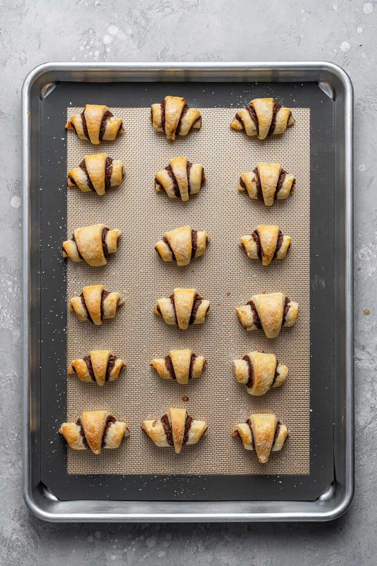 tray of baked rugelach cookies on silicone mat