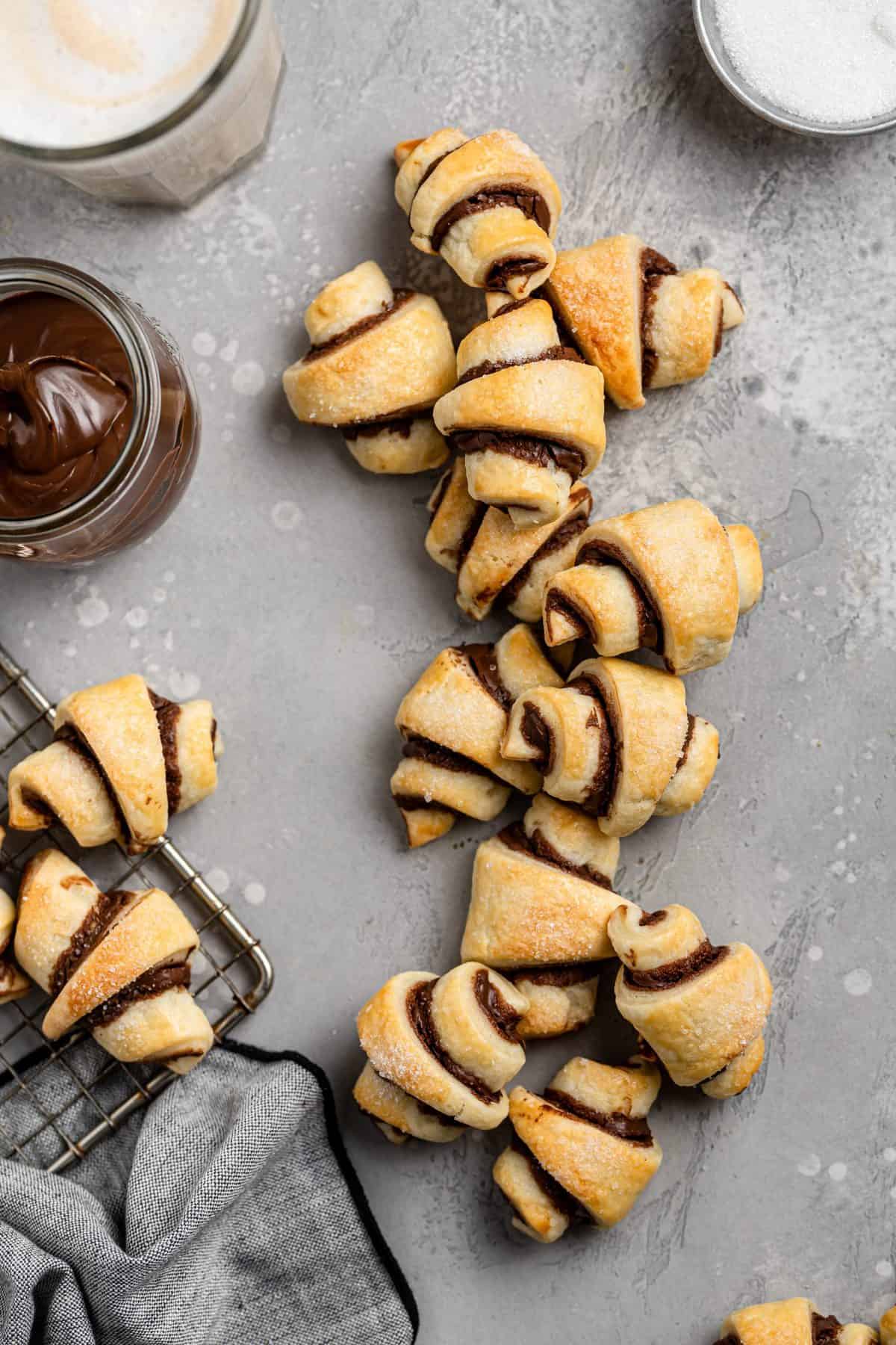 an overhead shot of a dozen rugelach cookies on metal background