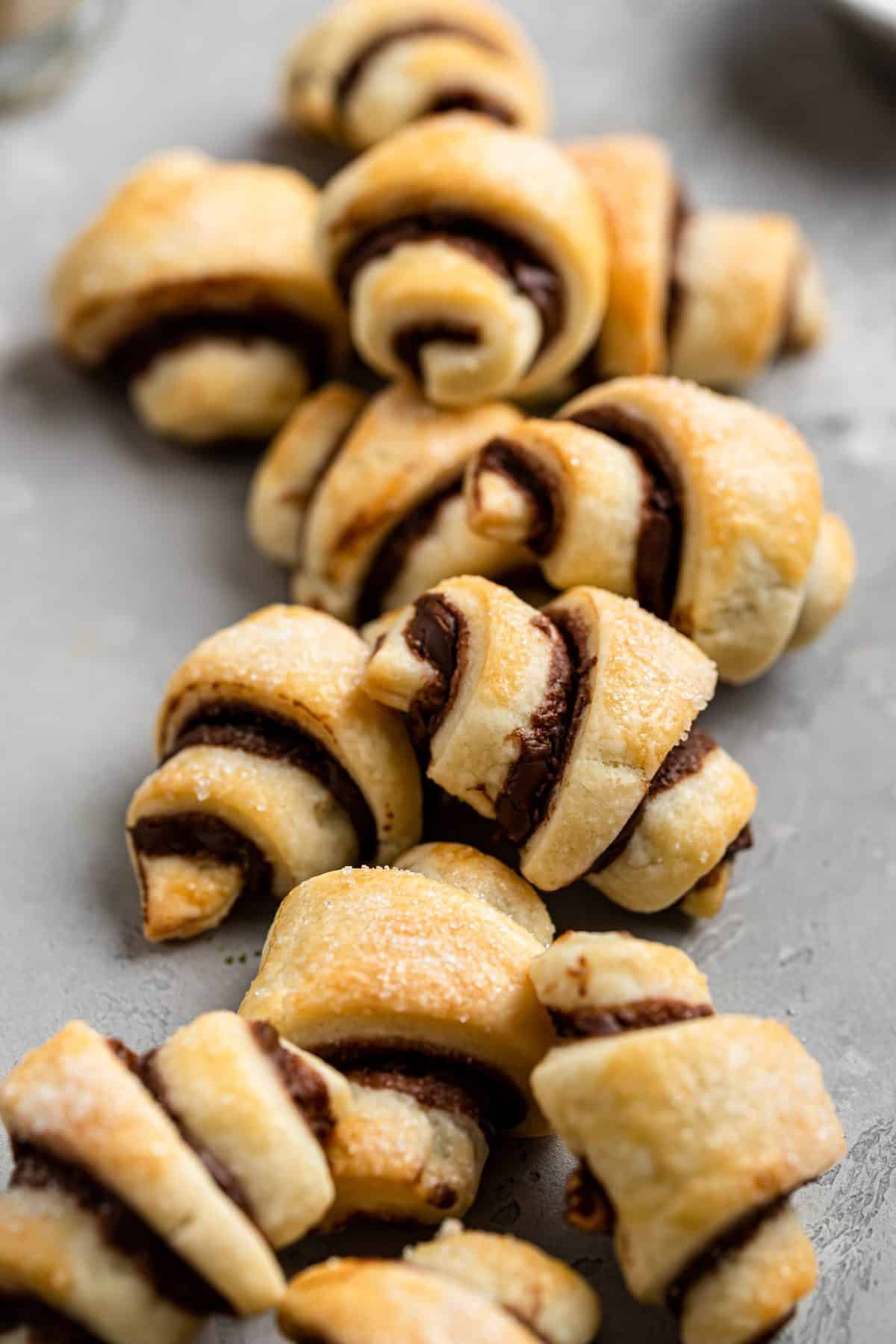 up close photo of strawberry filled rugelack cookies on metal background