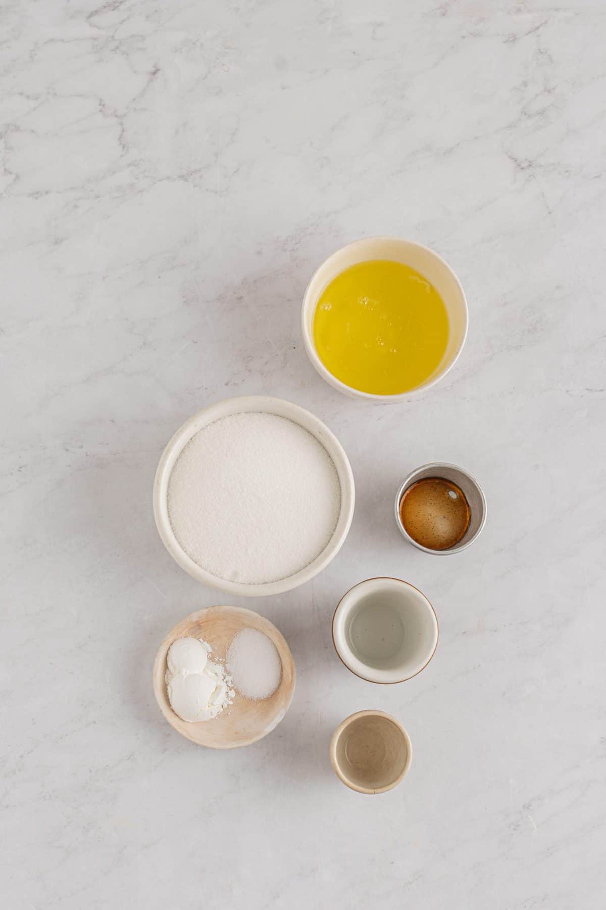 ingredients to make the pavlova layers on white marble background