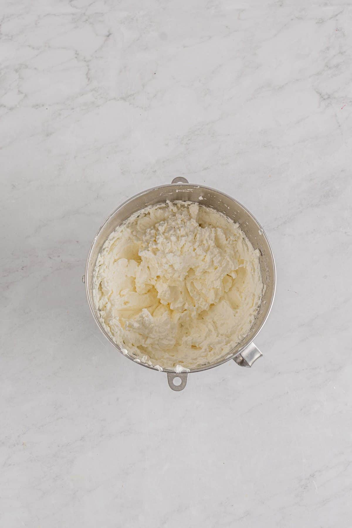 whipped cream in metal bowl for cherry pavlova tree