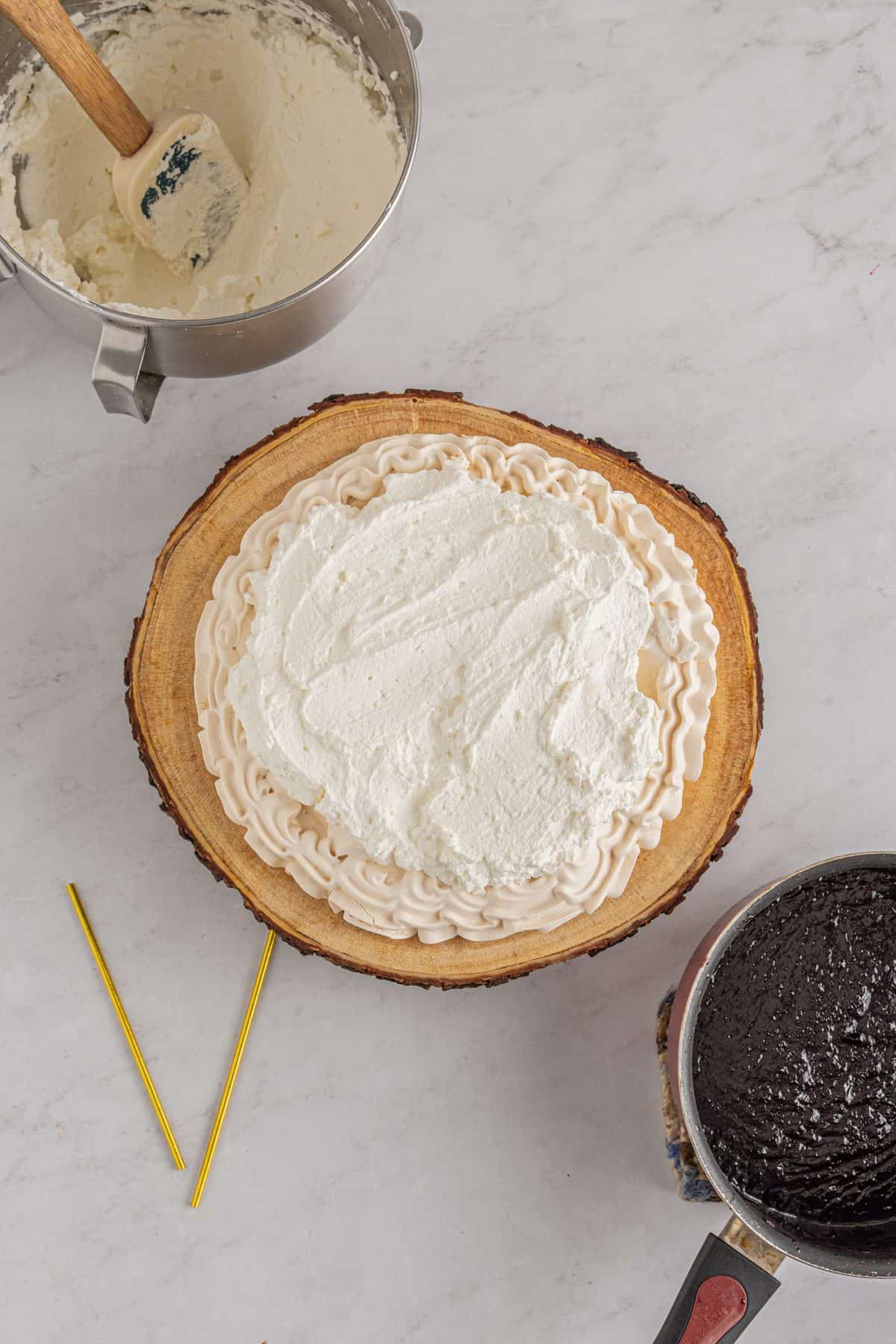 adding a layer of whipped cream to the meringue base