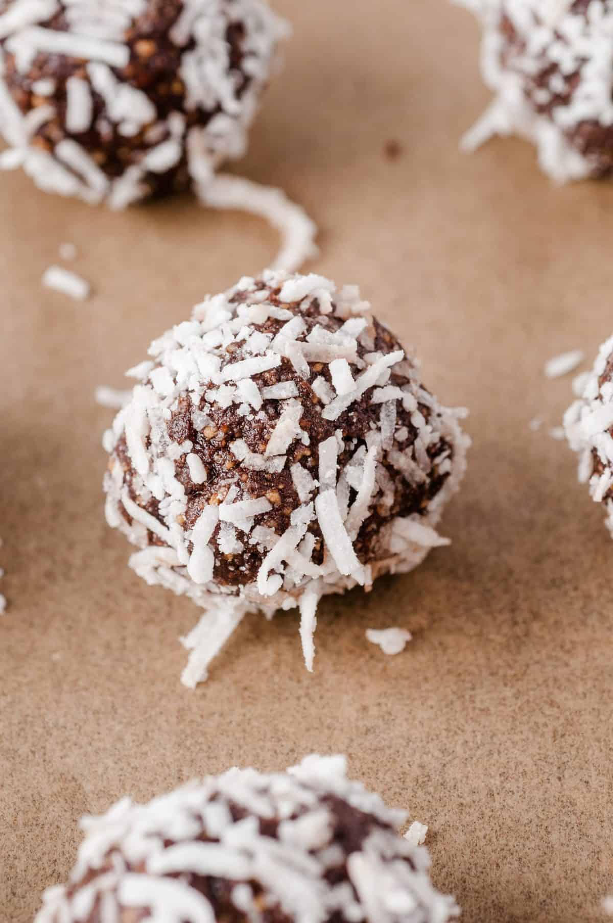 up close photo of chocolate rum ball rolled in shredded coconut