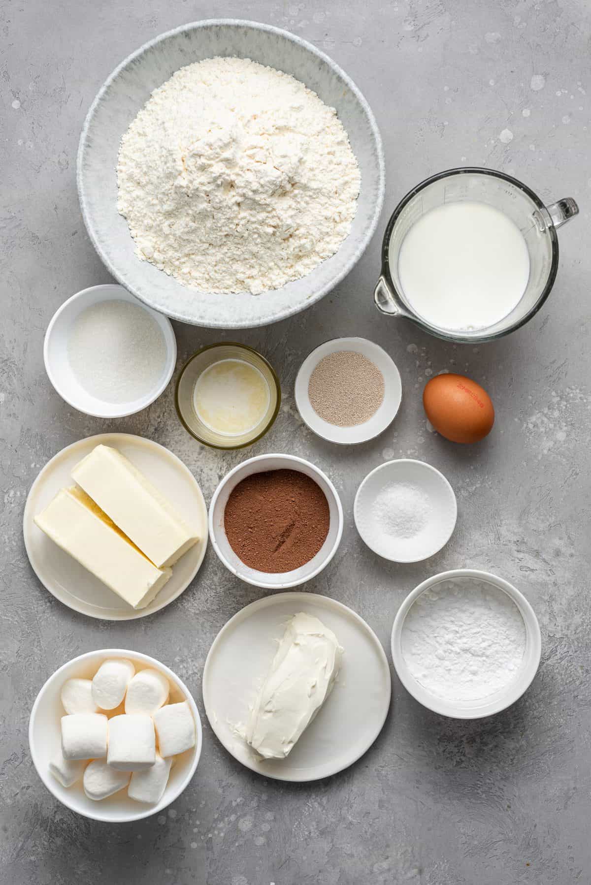 ingredients in bowls and plates to make hot chocolate cinnamon rolls