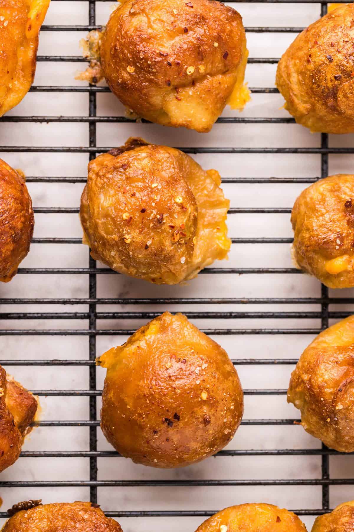 the baked beer cheese pretzel balls on a wire cooling rack