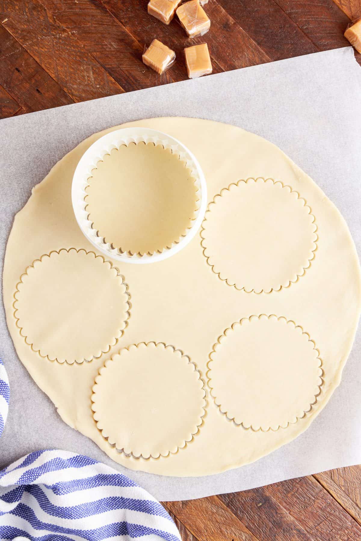 cutting out the round shapes in the pie crusts